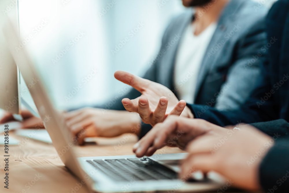close up. young business man using laptop in office close up. young business man using laptop in office