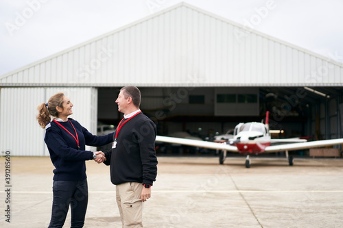 Female flight instructor congratulating her student on their first flight. photo