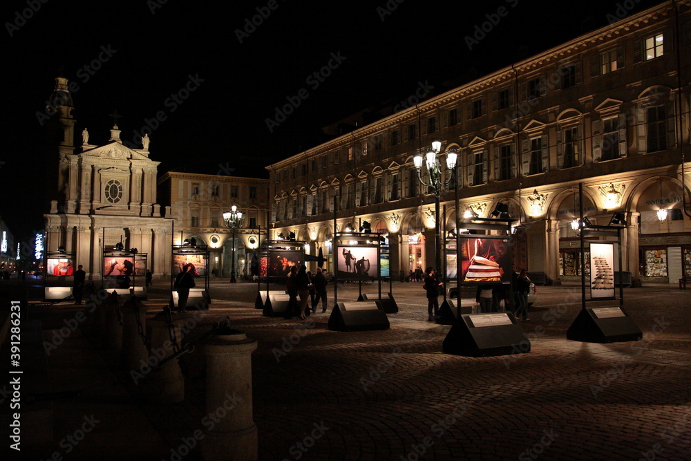 View of Baroque style Roman Catholic church San Carlo Borromeo and  Piazza San Carlo with Emanuele Filiberto Monument and art exhibition at night in Turin, Italy. 