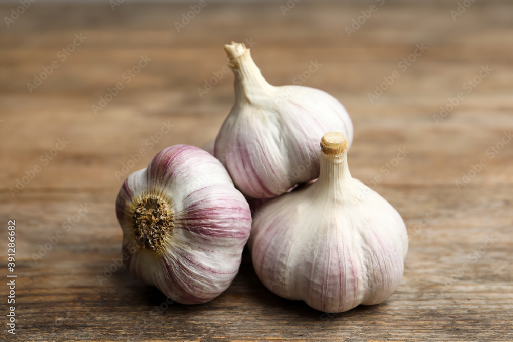 Fresh organic garlic on wooden table, closeup Fresh organic garlic on wooden table, closeup