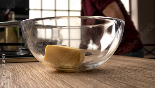 butter in a glass transparent bowl for kneading dough