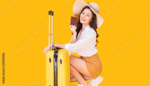 A beautiful Asian woman prepares to travel. She is very happy to relax on a summer holiday.
