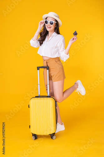 A beautiful Asian woman prepares to travel. She is very happy to relax on a summer holiday.