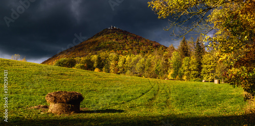A dark stormy cloud above the hill Milesovka. Milesovka is the highest hill in the CHKO Ceske Stredohori in Czech republic. photo