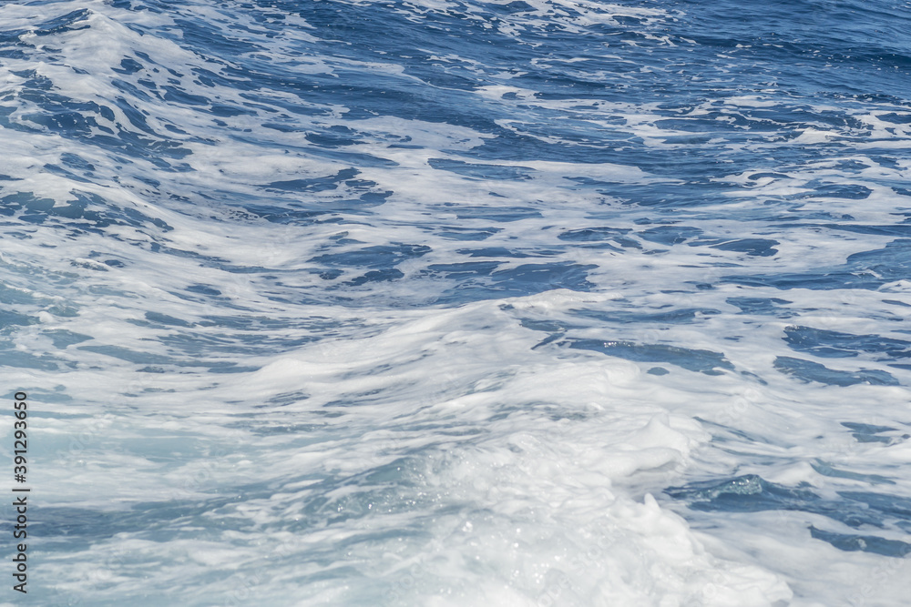 Waves of blue-white foamy sea water 