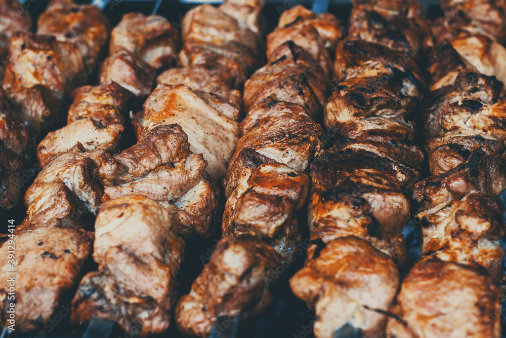 Grilled shish kebab close up. food festival in the city. roasting delicious food on a spit, food court. summer picnic Grilled shish kebab close up. food festival in the city. roasting delicious food on a spit, food court. summer picnic