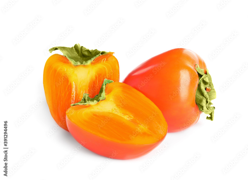 Delicious cut and whole fresh ripe persimmons isolated on white Delicious cut and whole fresh ripe persimmons isolated on white