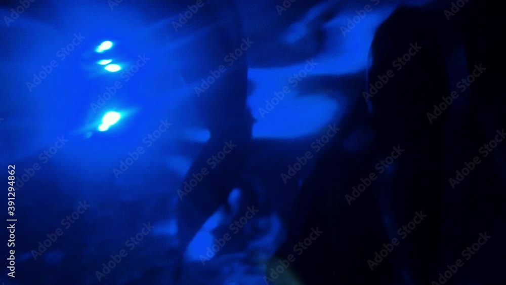 Underbelly of Fish Swimming in Blue Glowing Water Underbelly of Fish Swimming in Blue Glowing Water