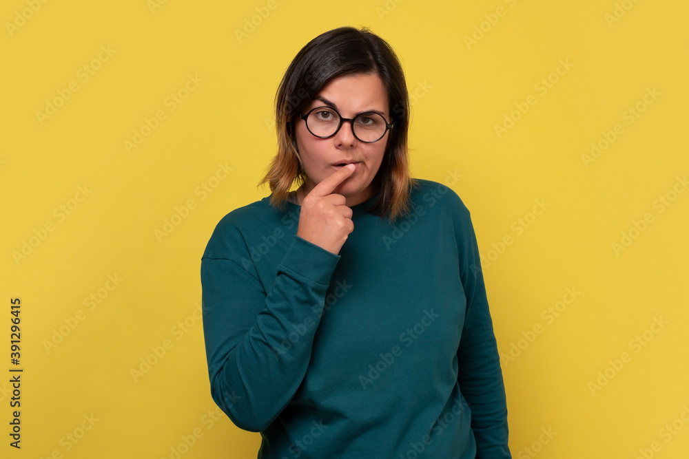 Caucasian woman with glasses having thoughtful look. Pensive female with puzzled expression thinking making a decisioan. Caucasian woman with glasses having thoughtful look. Pensive female with puzzled expression thinking making a decisioan.