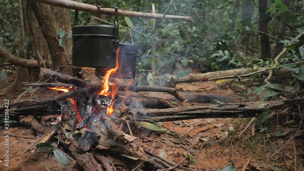 A field pot set on fire to cook rice in the forest. A field pot set on fire to cook rice in the forest.