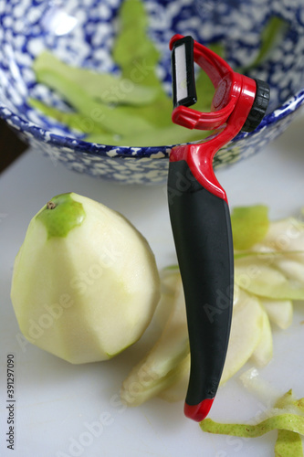 Peeled pear with use of peeler photo