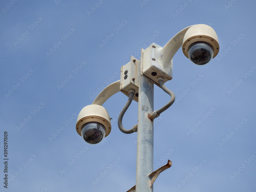 360 Degree fish eye dome CCTV is installed on column against blue sky. CCTV for security monitoring 360 Degree fish eye dome CCTV is installed on column against blue sky. CCTV for security monitoring