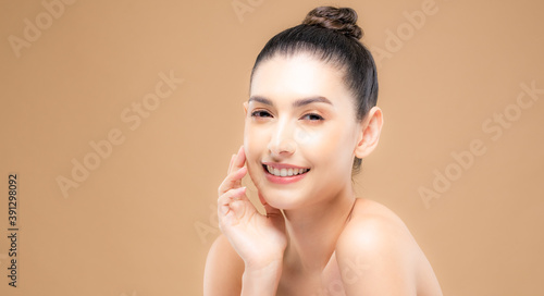 Beauty face of the young beautiful woman skin natural make up.  skin color background. close up face beauty portrait