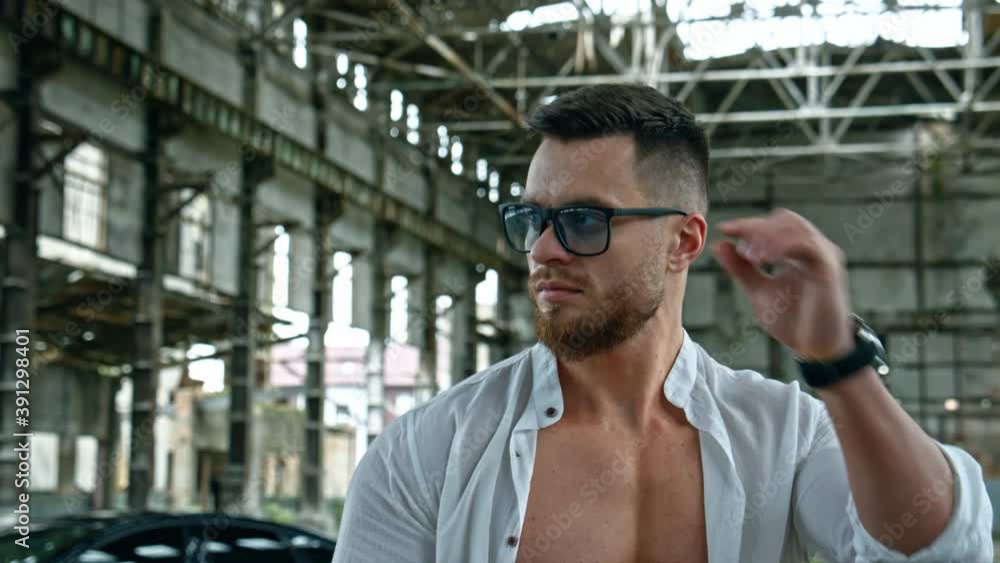 Bodybuilder with naked torso. Portrait of handsome muscular man in glasses Bodybuilder with naked torso. Portrait of handsome muscular man in glasses