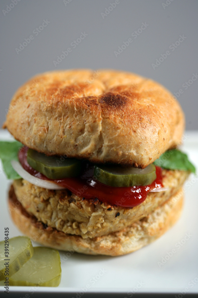 Burger with meat, onion, pickled cucumbers and ketchup Burger with meat, onion, pickled cucumbers and ketchup