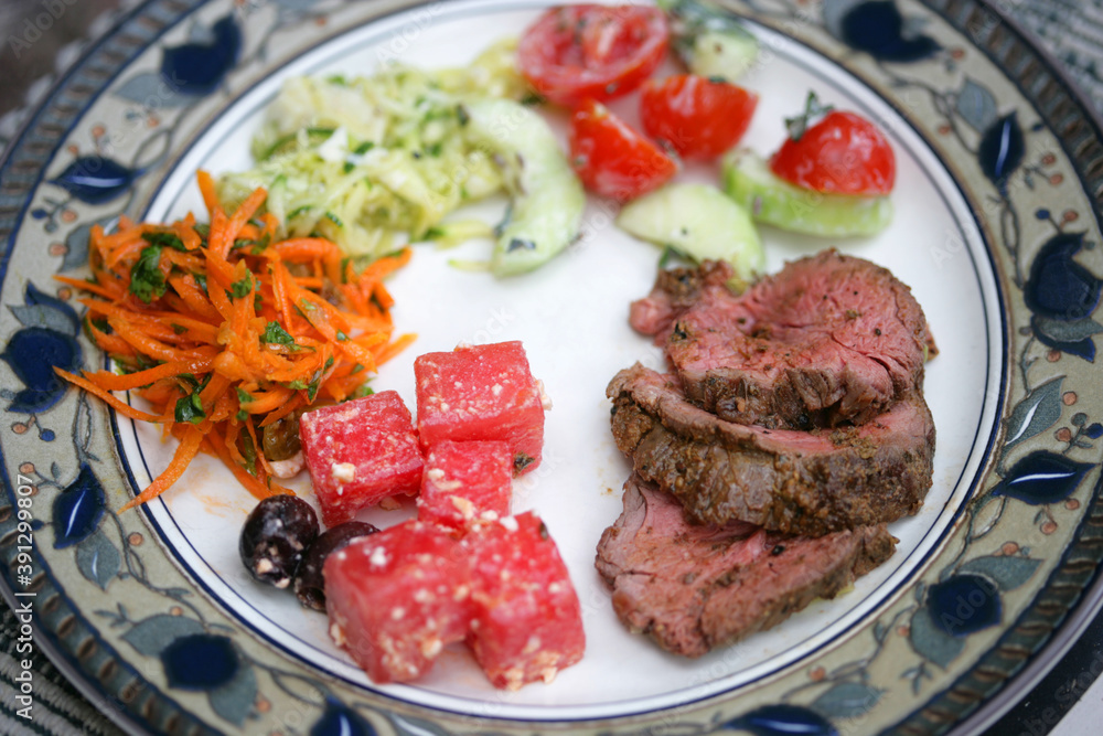 Close up of beef tenderloin with salad choice Close up of beef tenderloin with salad choice