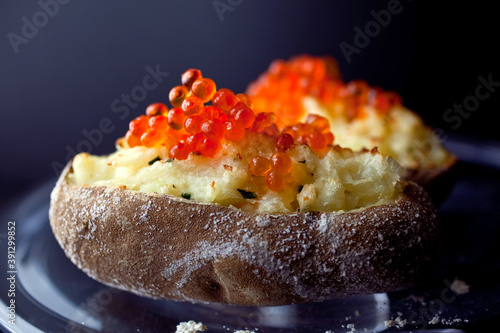 Baked potatoes with salmon roe and creme fraiche