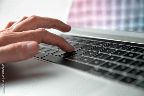 Photos close up. man using a keyboard shortcut on a laptop keyboard.