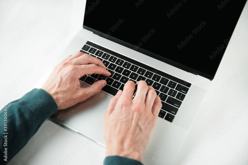 close up. casual male typing on a laptop keyboard. close up. casual male typing on a laptop keyboard.
