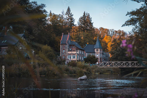 Traditionelle deutsches Haus am Ufer eines Flusses, während des Herbst im Harz (Querformat)