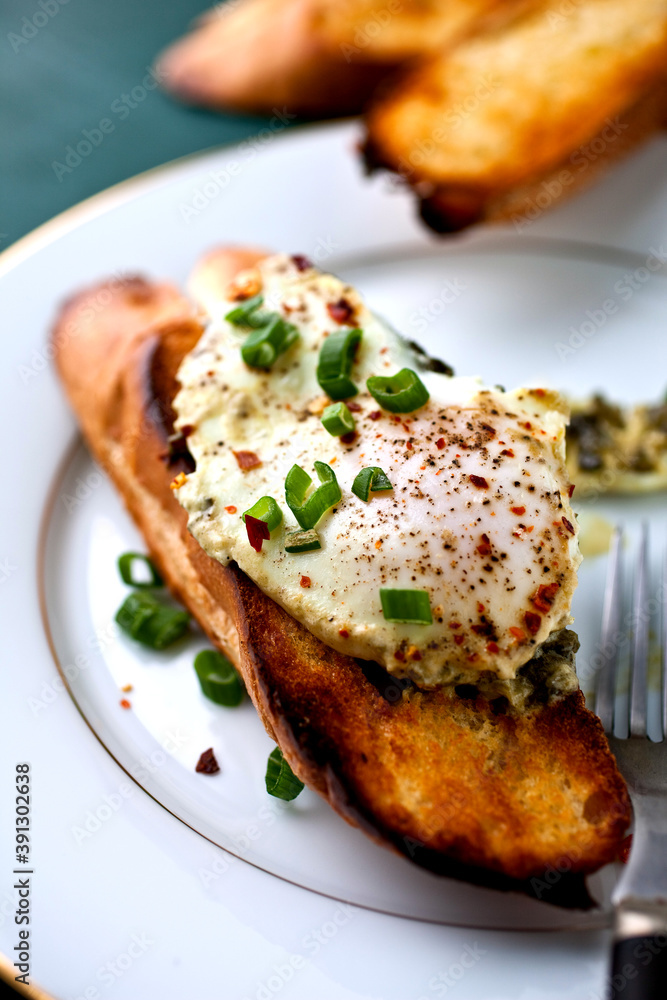 Eggs poached in buttery Sorrel sauce on toasted bread Eggs poached in buttery Sorrel sauce on toasted bread