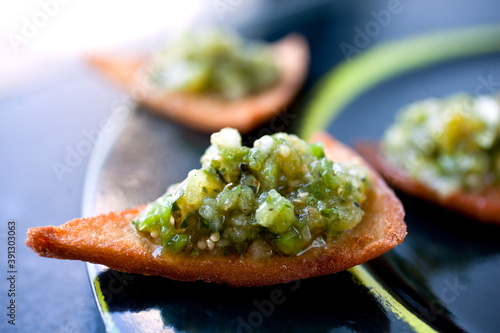 Close up of chip with roasted tomatillo salsa photo