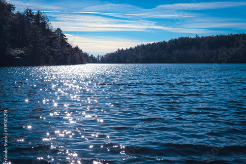 beautiful Lake Minnewaska in upstate New York - low angle view of the water with the sun reflecting  photo