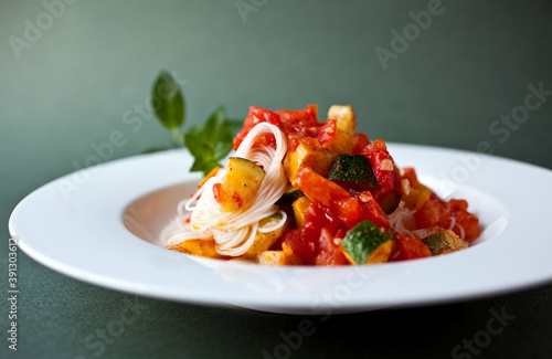 Close up of rice noodles with zucchini, tomatoes and mint