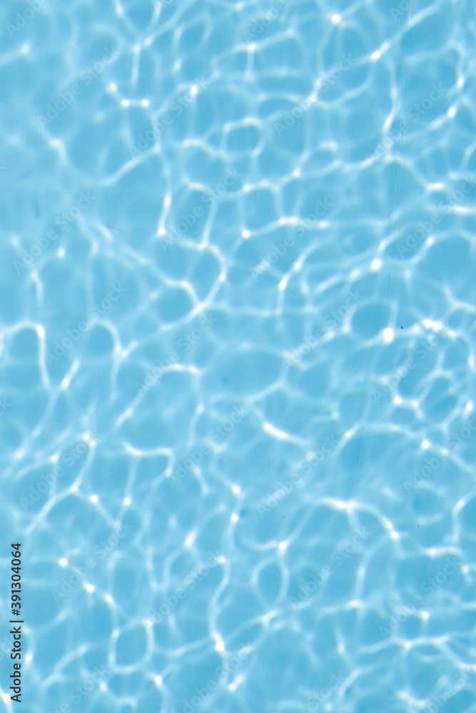 Light blue water in the swimming pool with reflection, 
beautiful background for gift card, with space for text