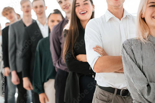 young woman standing in line among diverse young people