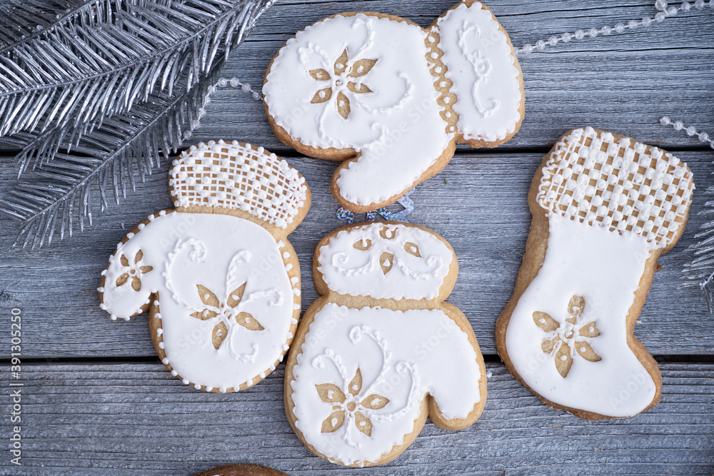 Christmas cookies decorated with royal icing on wooden table