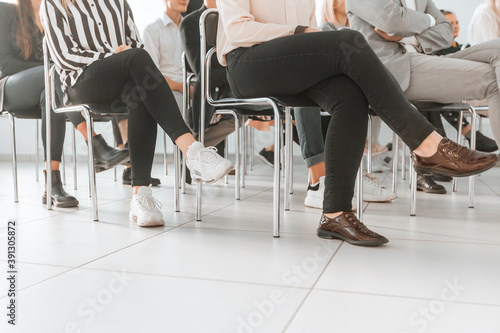 cropped image of a group of employees sitting in a conference r
