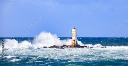 lighthouse of the mangiabarche of calasetta in a stormy day, sardinia
 photo