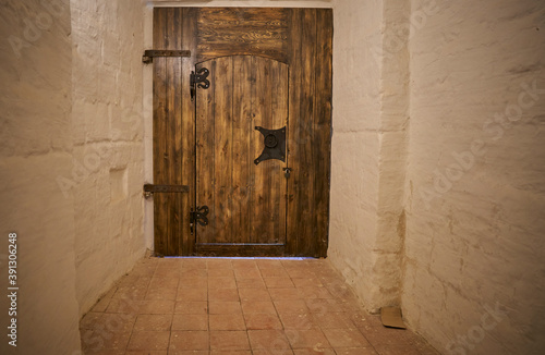 Fotografie antique wooden door with iron ring handle and lock in the monastery building