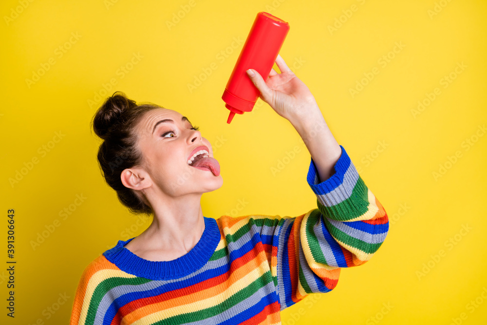 Photo of funny attractive cute girl hungry eat ketchup tongue out isolated on shine yellow color background Photo of funny attractive cute girl hungry eat ketchup tongue out isolated on shine yellow color background
