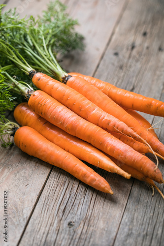 Fresh carrots bunch on rustic background. Healthy vegan vegetable food.