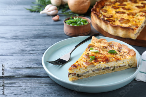 Delicious pie with mushrooms and cheese served on grey wooden table