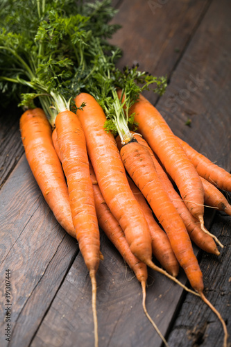 Fresh carrots bunch on rustic background. Healthy vegan vegetable food.