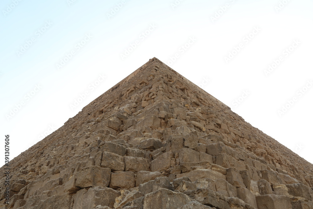 Low angle view of one of the great historical pyramids of Giza, one of the Seven Wonders of the World, Giza - Egypt Low angle view of one of the great historical pyramids of Giza, one of the Seven Wonders of the World, Giza - Egypt