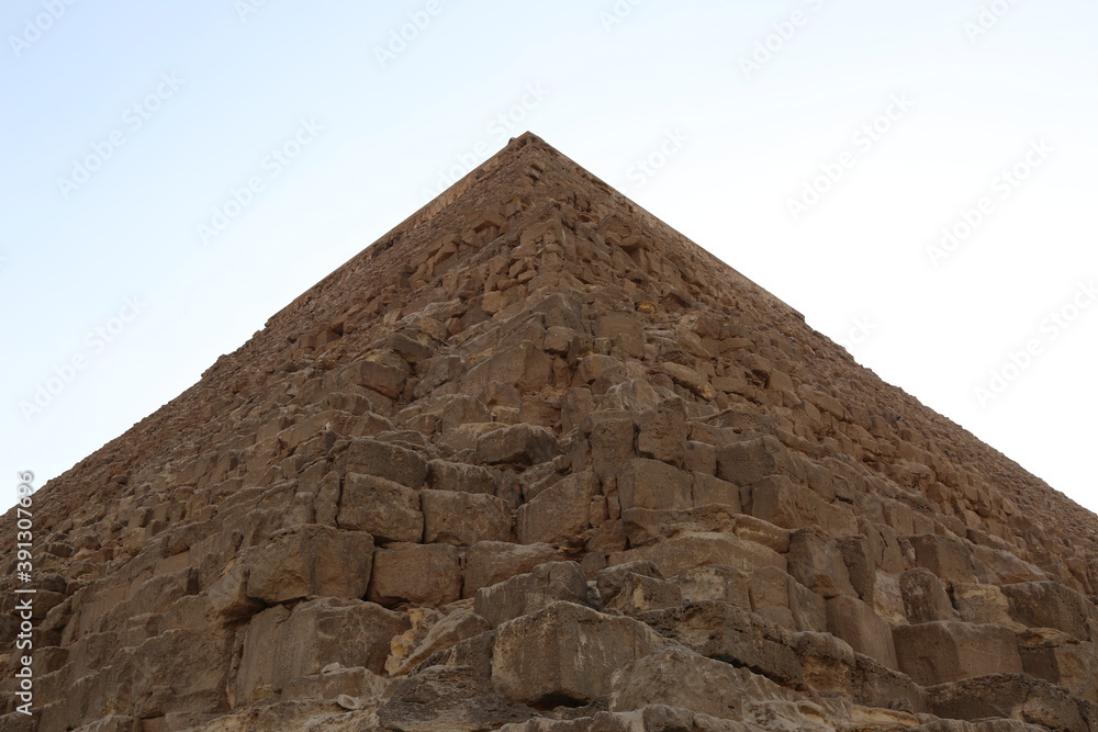 Low angle view of one of the great historical pyramids of Giza, one of the Seven Wonders of the World, Giza - Egypt Low angle view of one of the great historical pyramids of Giza, one of the Seven Wonders of the World, Giza - Egypt