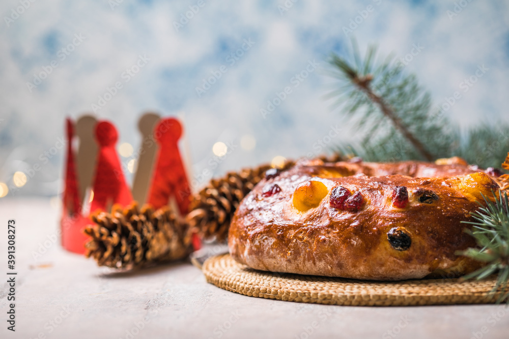 Fototapeta premium Rosca de reyes, spanish three kings cake eaten on epiphany day, on a gray rustic table