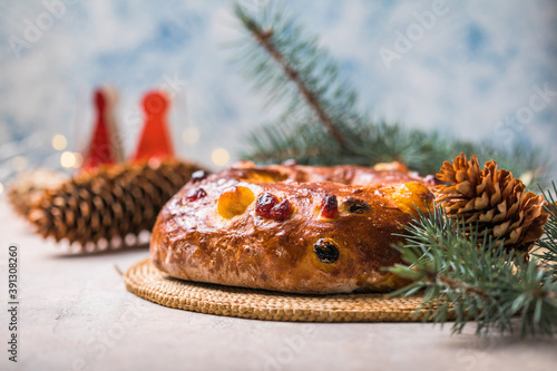 Rosca de reyes, spanish three kings cake eaten on epiphany day, on a gray rustic table photo