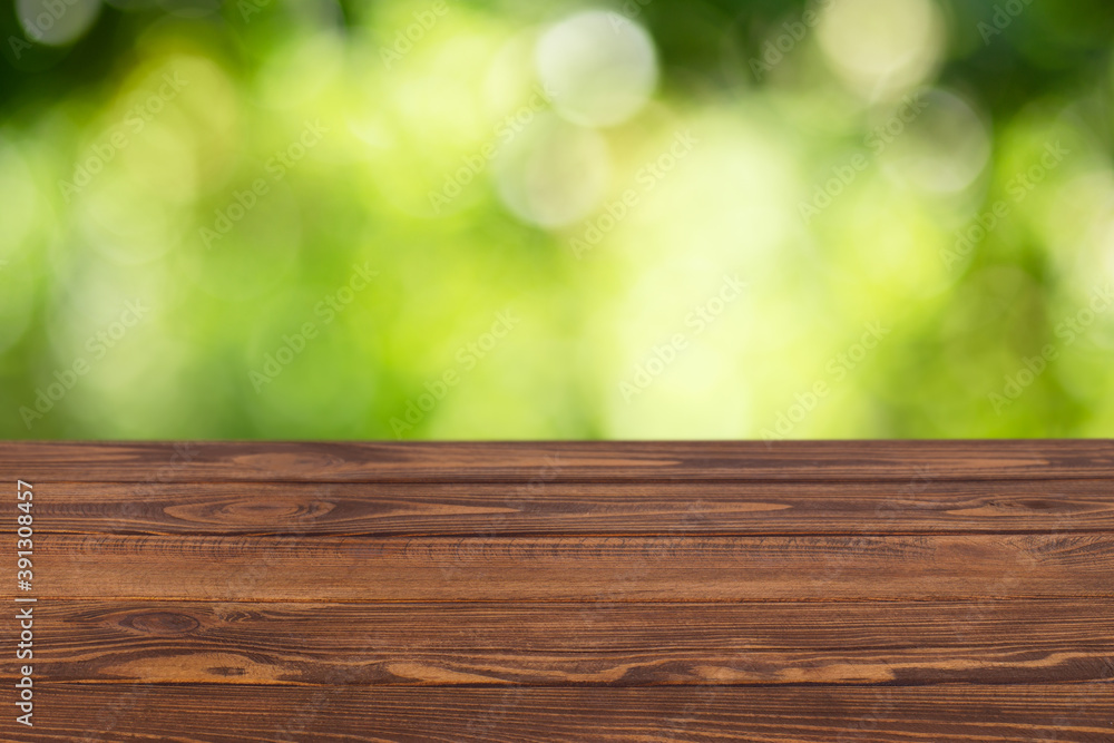 wooden empty table with blurred green garden wooden empty table with blurred green garden