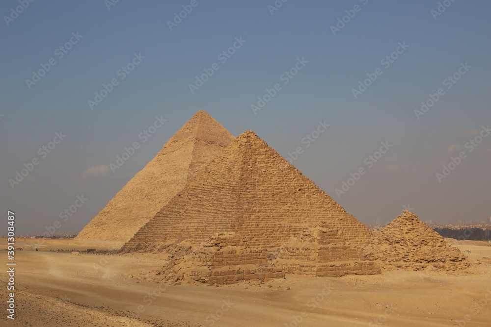 A picture of five of the great historical pyramids of Giza in the light of day, one of the Seven Wonders of the World, Giza - Egypt