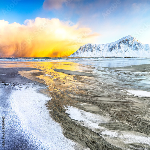 Incredible winter scenery on Skagsanden beach with illuminated clouds during sunrise.