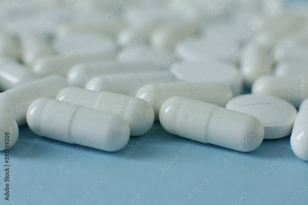 White pills on blue background White pills on blue background