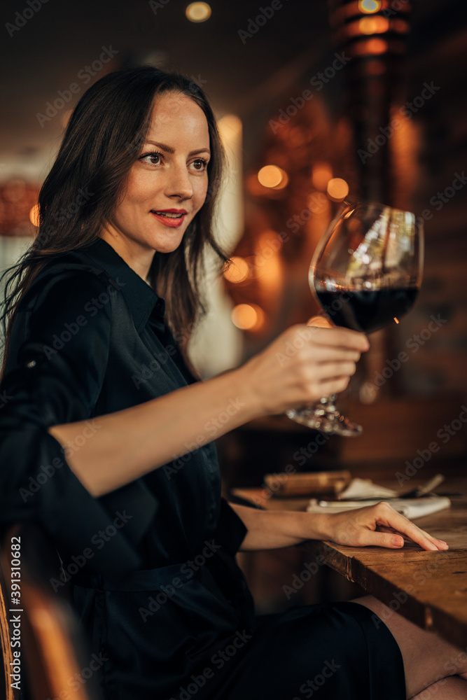 woman toasting with glass of wine