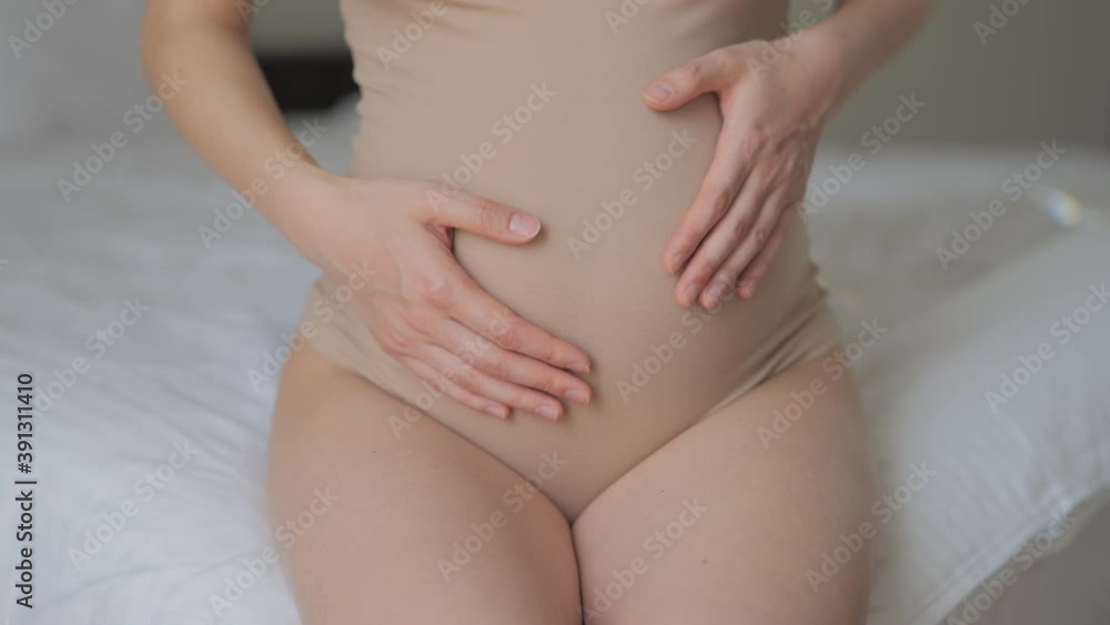 Close up of woman pregnant belly. Future mother petting abdomen and showing heart shape. Concept of maternity, motherhood, pregnancy, love and family. Close up of woman pregnant belly. Future mother petting abdomen and showing heart shape. Concept of maternity, motherhood, pregnancy, love and family.