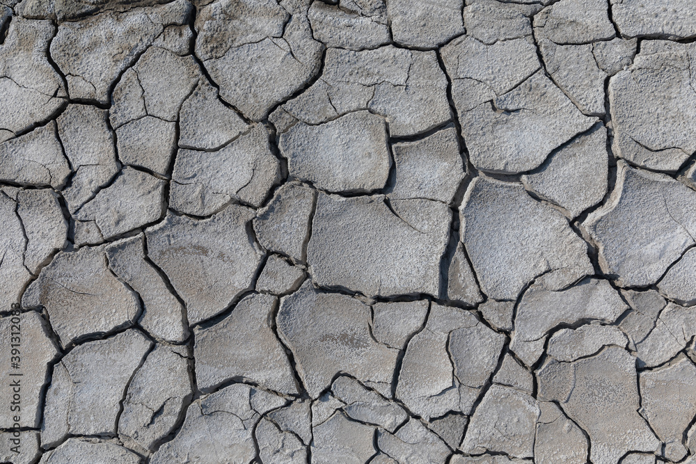 The texture of dried cracked mud flowed out of a mud volcano