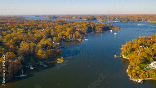 Fotografia Aerial view of colorful sailboat moorings, docks,   and bright golden foliage on